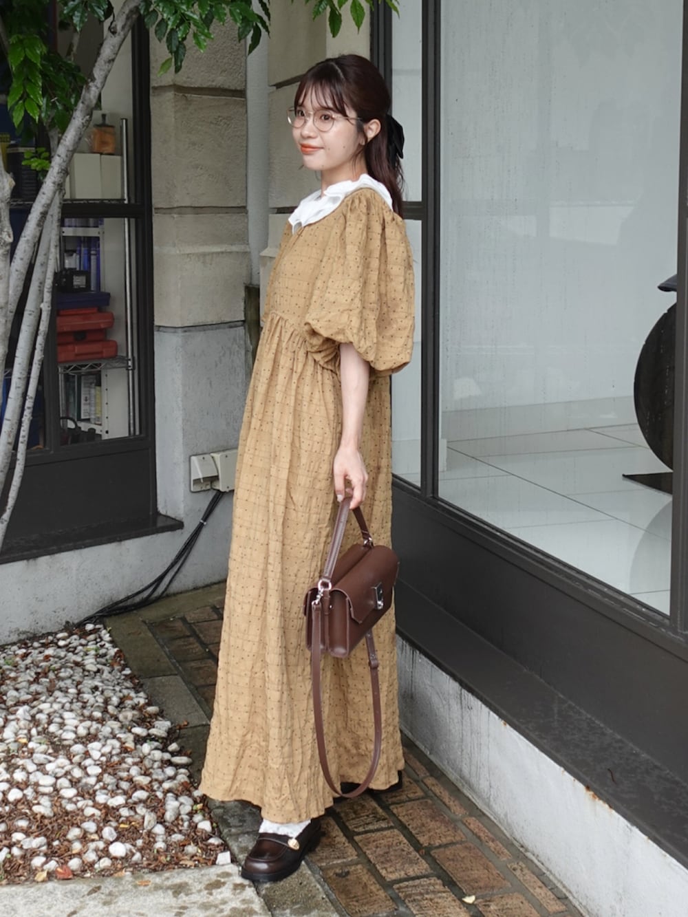 ブラウン系のワンピース、ブラウン系のローファー、ブラウン系のショルダーバッグを着用したレディースの夏コーディネートの3枚目の写真