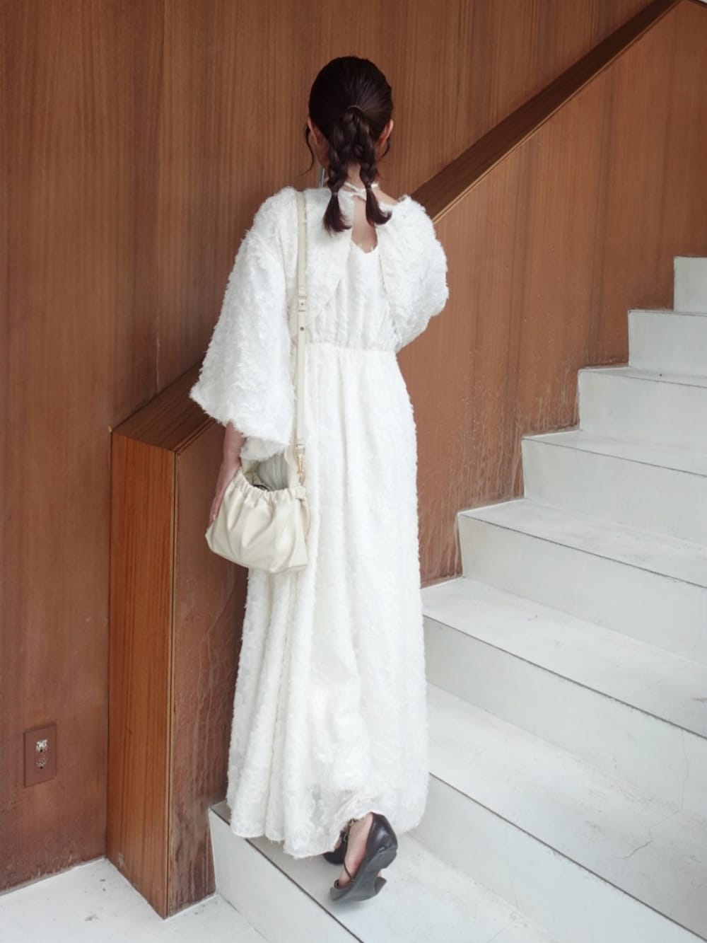 ホワイト系のワンピース、ブラウン系のパンプス、ホワイト系のショルダーバッグを着用したレディースの夏コーディネートの3枚目の写真