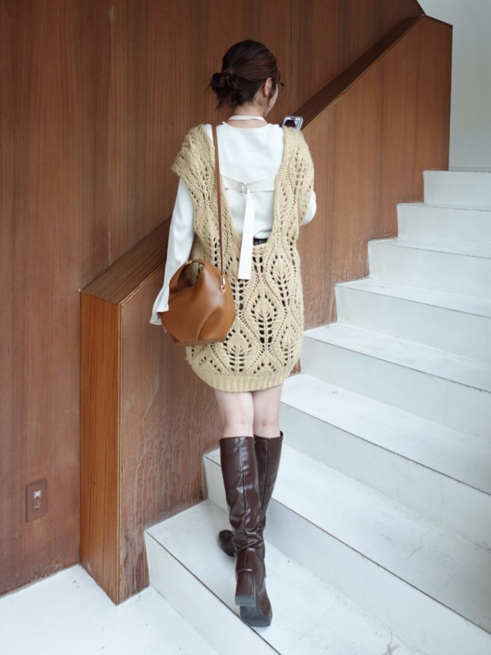 ベージュ系のベスト、ブラウン系のパンツ、ブラウン系のブーツを着用したレディースの秋コーディネートの4枚目の写真