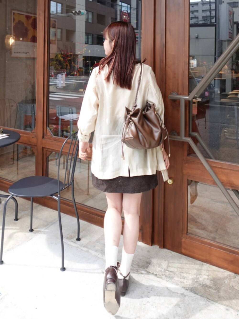 ホワイト系のチューブトップ、ブラウン系のスカート、ベージュ系のシャツ/ブラウスを着用したレディースの秋コーディネートの3枚目の写真