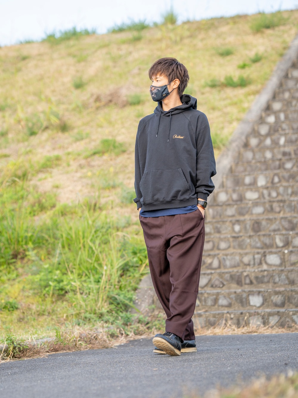 ブラック系のパーカー、ブルー系のTシャツ/カットソー、ブラウン系のパンツを着用したメンズの秋コーディネートの2枚目の写真