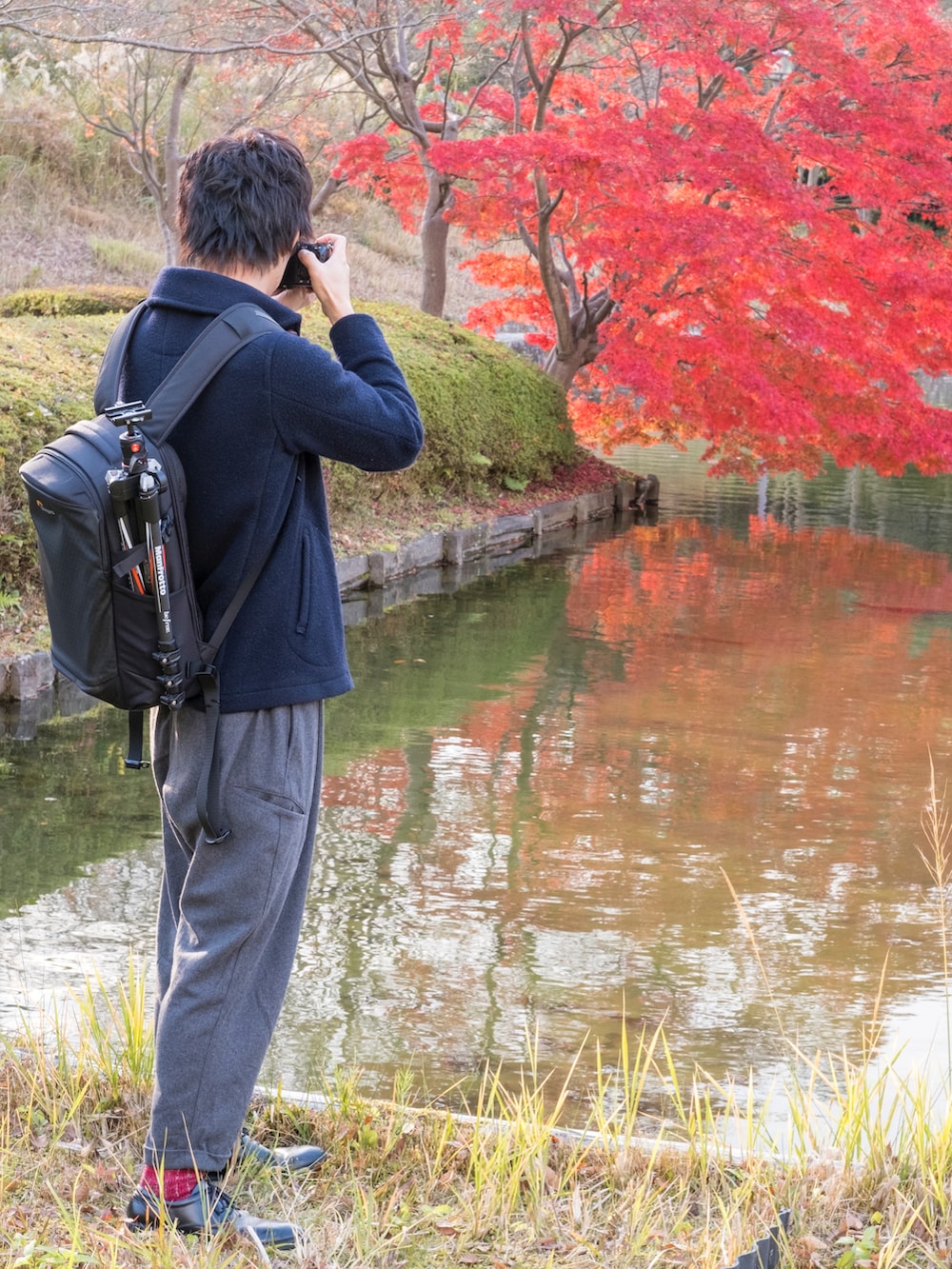 ブルー系のブルゾン、ホワイト系のシャツ/ブラウス、ブラック系のバックパック/リュックを着用したメンズの秋コーディネートの2枚目の写真