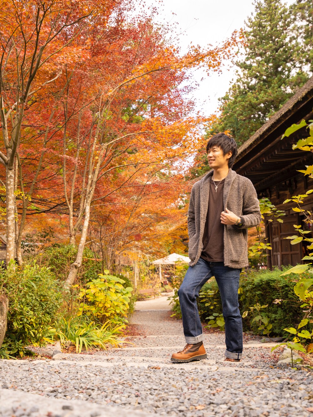 ブラウン系のTシャツ/カットソー、ブラウン系のジャケット/アウター、ブルー系のデニムパンツを着用したメンズの冬コーディネートの2枚目の写真