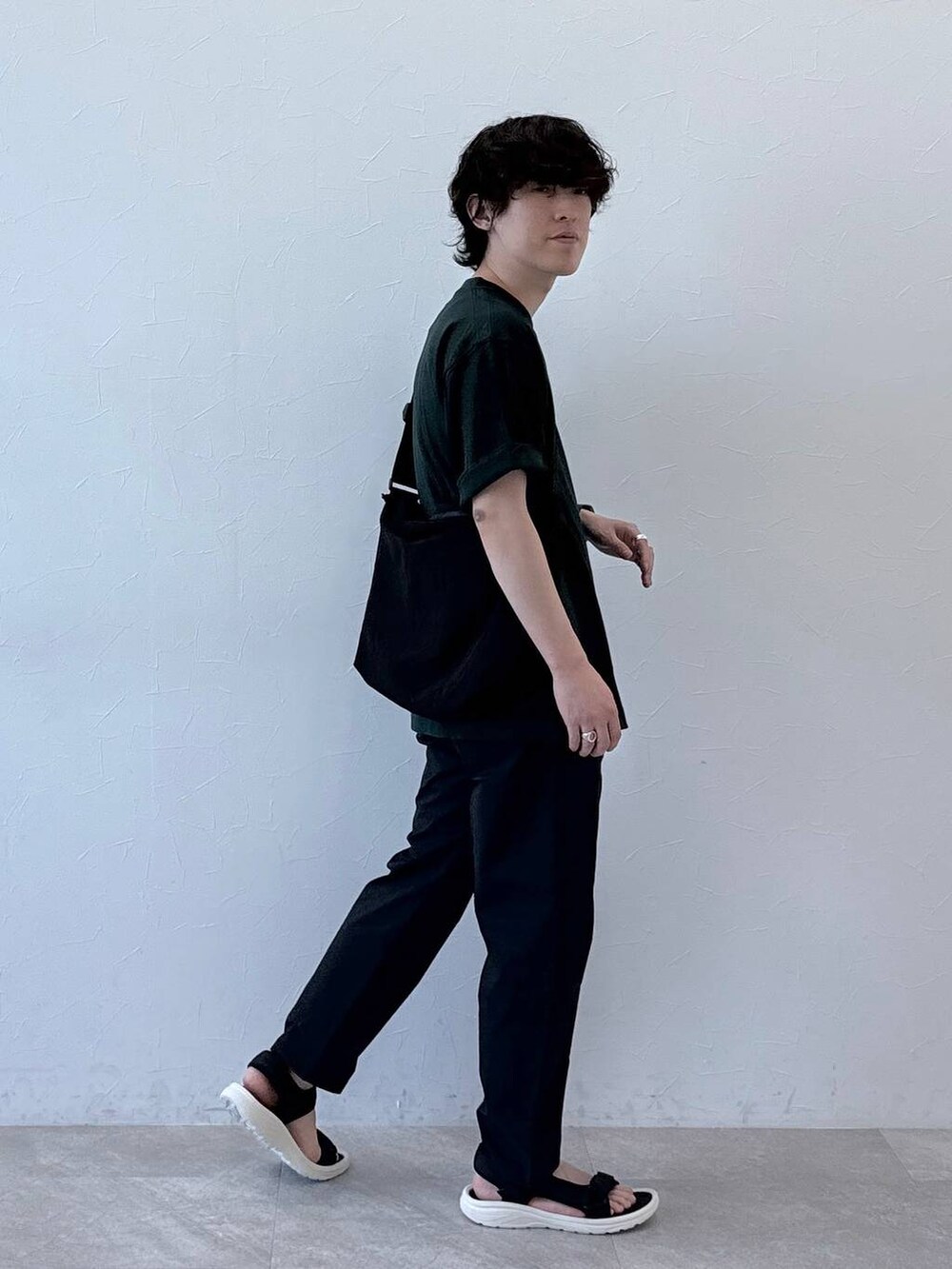 ブラック系のショルダーバッグ、グレー系のその他パンツ、グリーン系のTシャツ/カットソーを着用したメンズの夏コーディネートの3枚目の写真