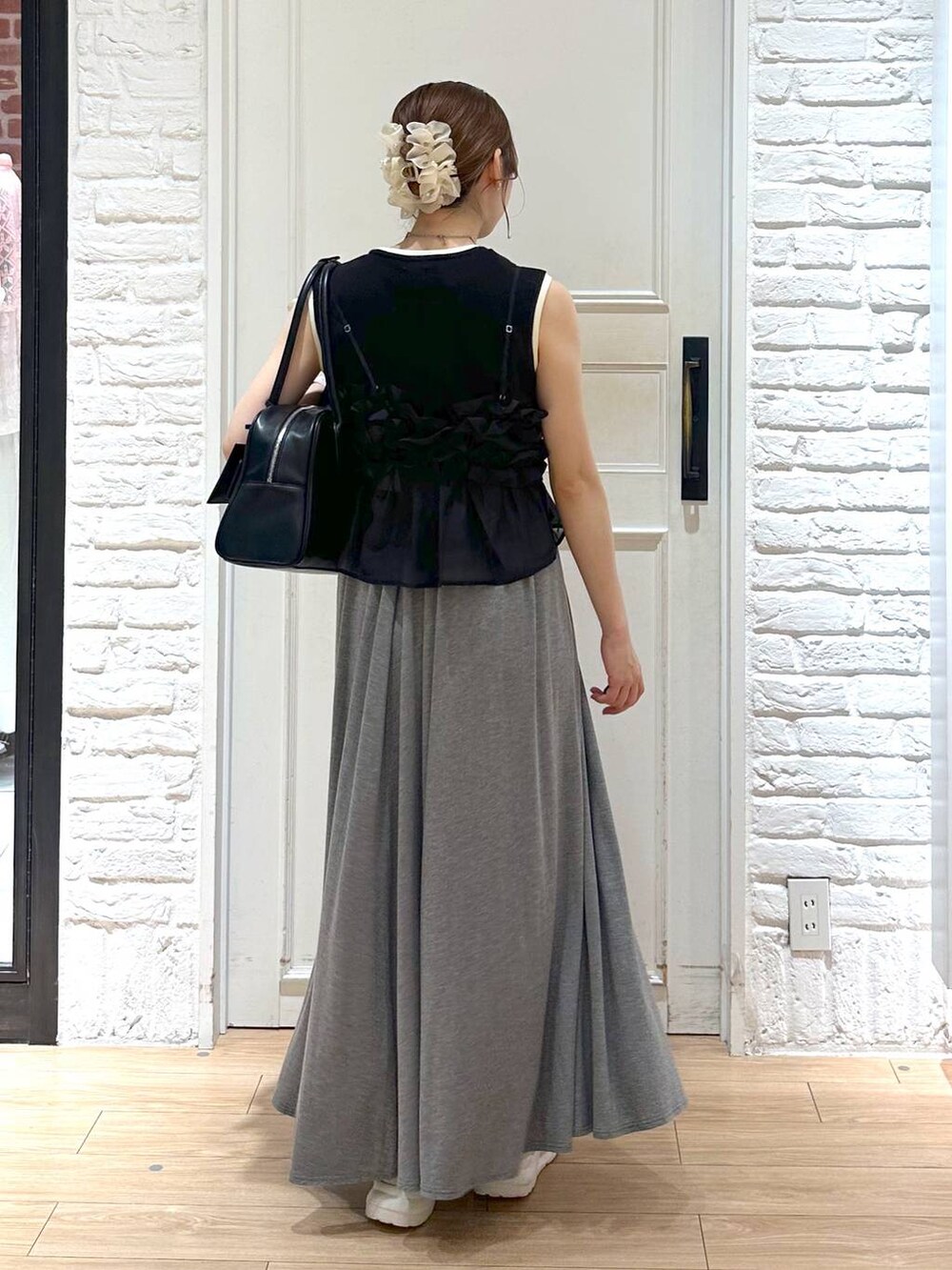ブラック系のキャミソール、グレー系のスカート、ブラック系のタンクトップを着用したレディースの夏コーディネートの2枚目の写真
