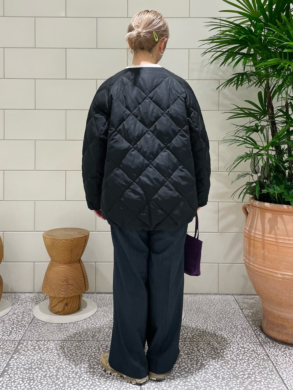 ブラック系のその他アウター、ホワイト系のカーディガン/ボレロ、ブラック系のその他パンツを着用したレディースの冬コーディネートの3枚目の写真