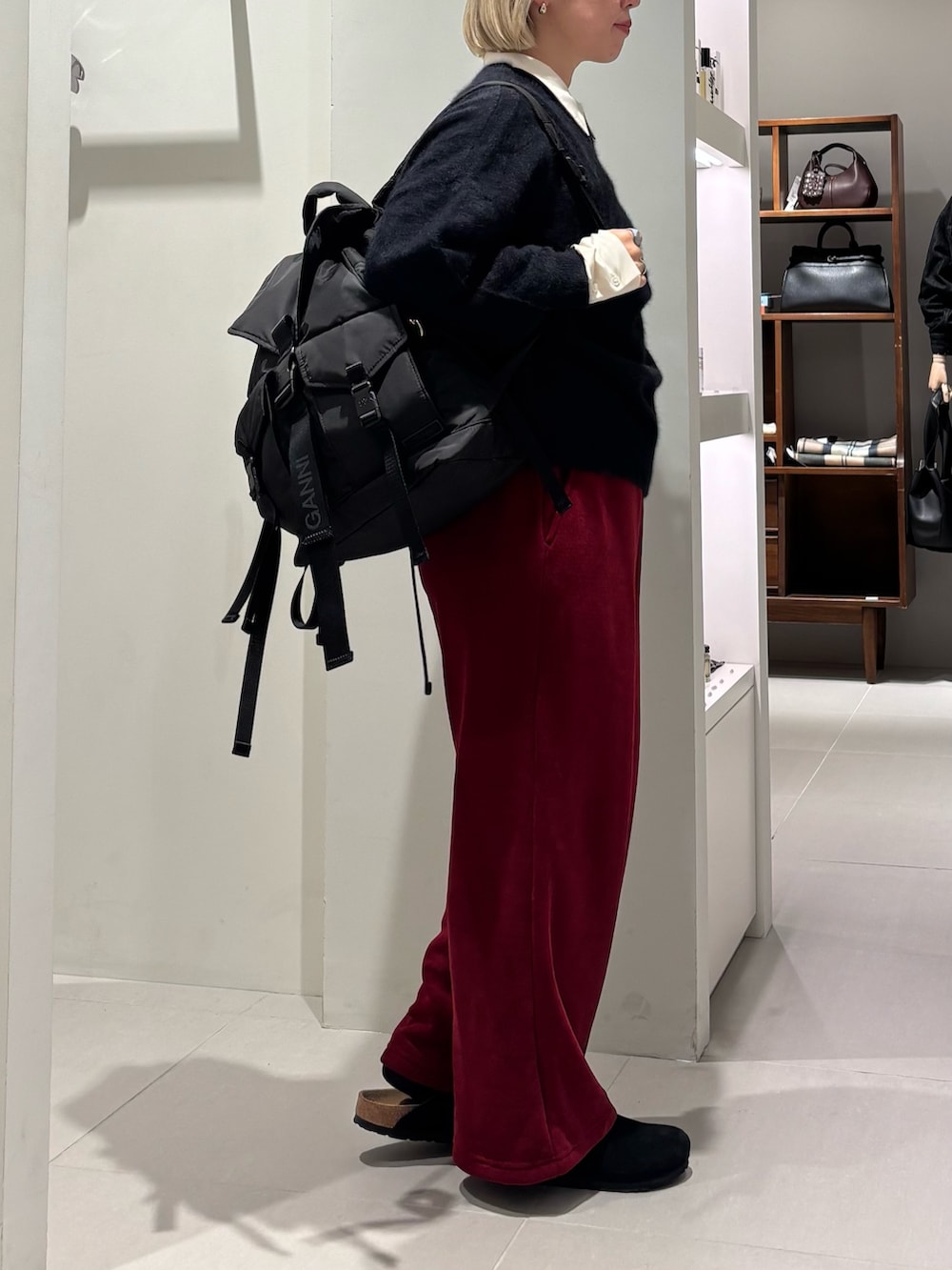 ホワイト系のTシャツ/カットソー、ブラック系のニット/セーター、ブラック系のバックパック/リュックを着用したレディースの秋コーディネートの2枚目の写真