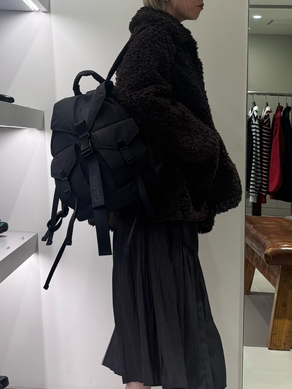 ブラウン系のその他アウター、グレー系のワンピース、ブラック系のバックパック/リュックを着用したレディースの秋コーディネートの2枚目の写真