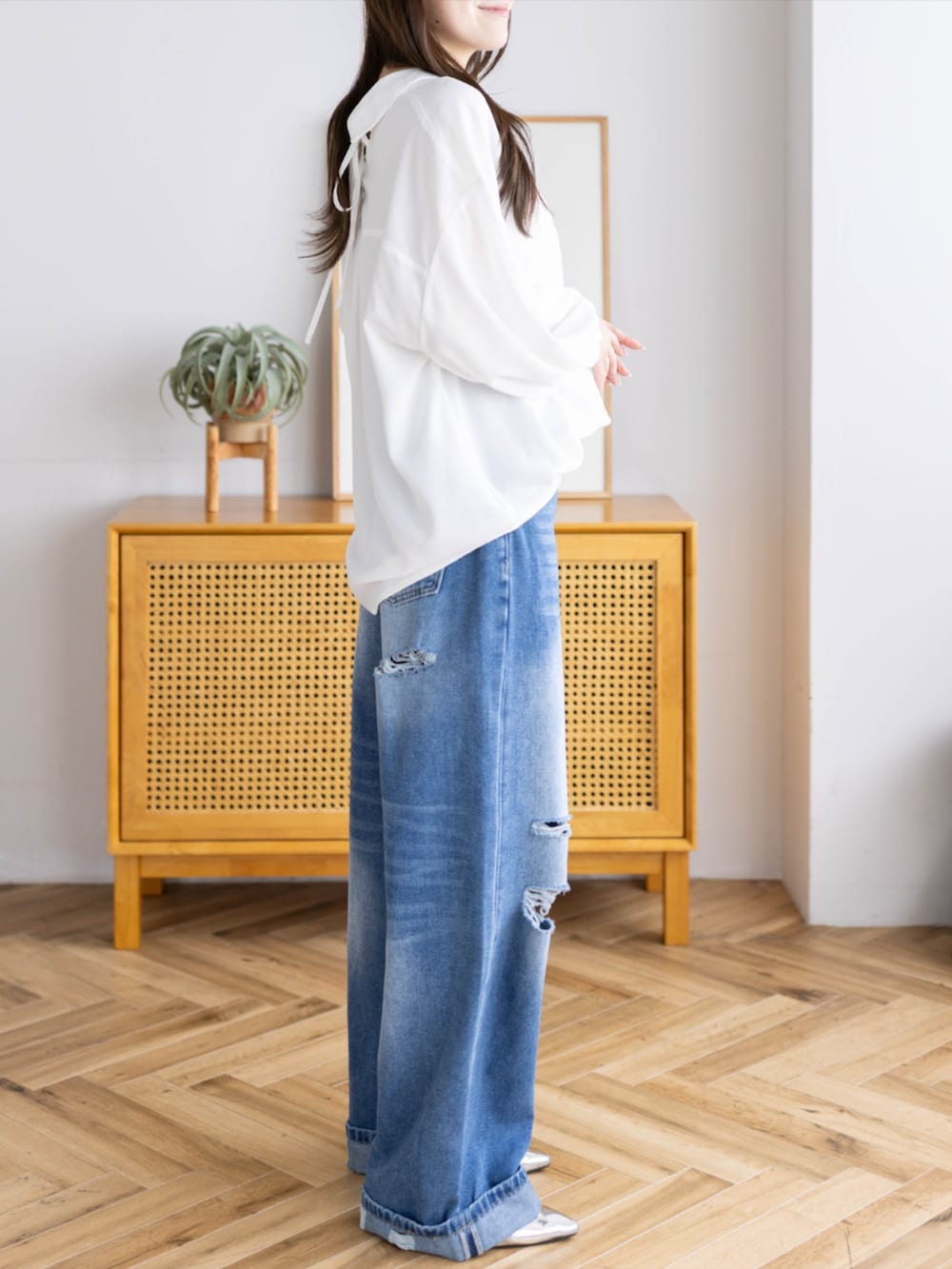 シルバー系のパンプス、ブルー系のデニムパンツ、ホワイト系のシャツ/ブラウスを着用したレディースの夏コーディネートの4枚目の写真