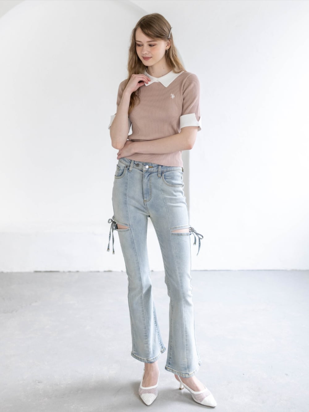 ホワイト系のパンプス、ブルー系のデニムパンツ、ピンク系のニット/セーターを着用したレディースの夏コーディネートの2枚目の写真