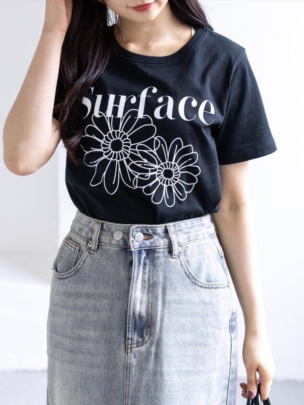 ホワイト系のスニーカー、ブルー系のスカート、ブラック系のTシャツ/カットソーを着用したレディースの春コーディネートの7枚目の写真
