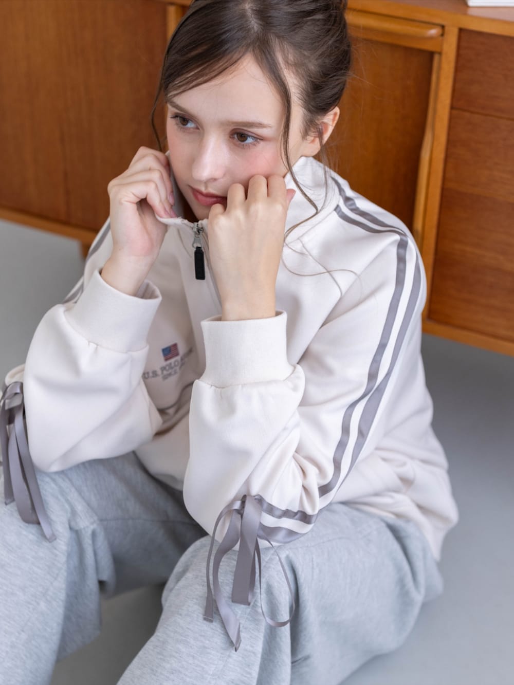 ゴールド系のスニーカー、グレー系のスウェットパンツ、ホワイト系のTシャツ/カットソーを着用したレディースの秋コーディネートの10枚目の写真