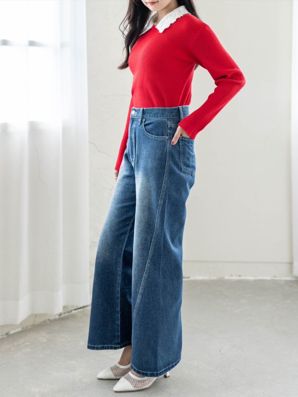ホワイト系のパンプス、ブルー系のデニムパンツ、レッド系のニット/セーターを着用したレディースの夏コーディネートの2枚目の写真