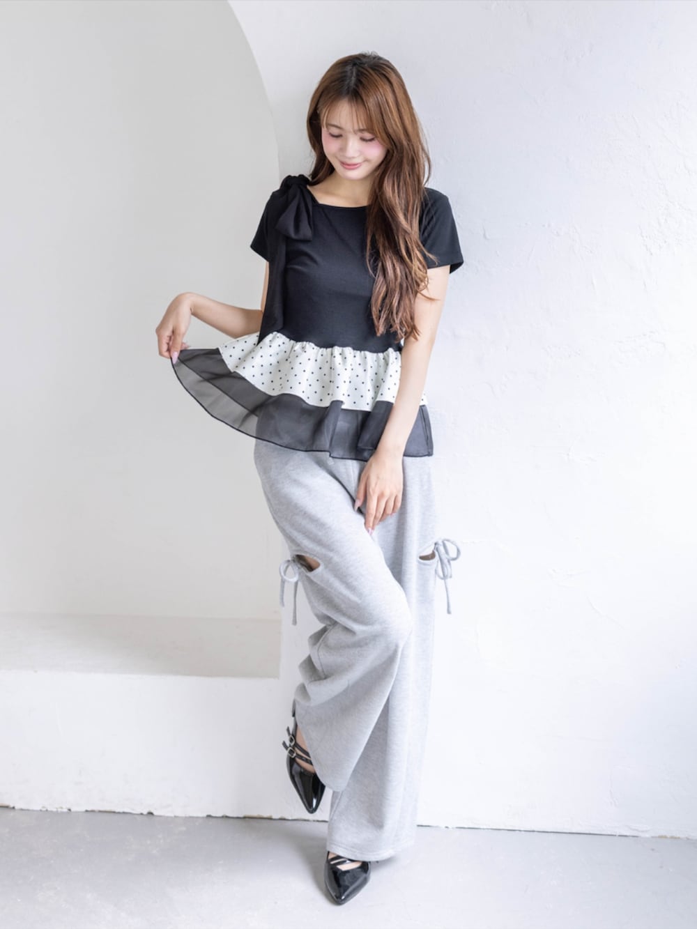 ブラック系のパンプス、グレー系のスウェットパンツ、ブラック系のTシャツ/カットソーを着用したレディースの夏コーディネートの2枚目の写真