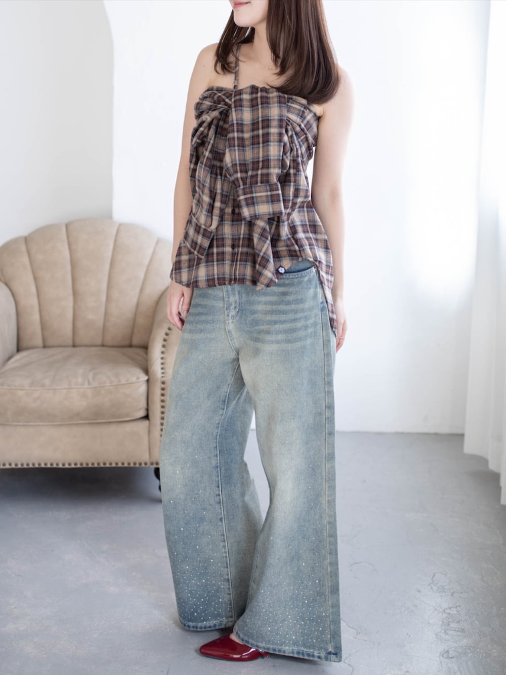 レッド系のパンプス、ブルー系のデニムパンツ、ブラウン系のシャツ/ブラウスを着用したレディースの秋コーディネートの2枚目の写真