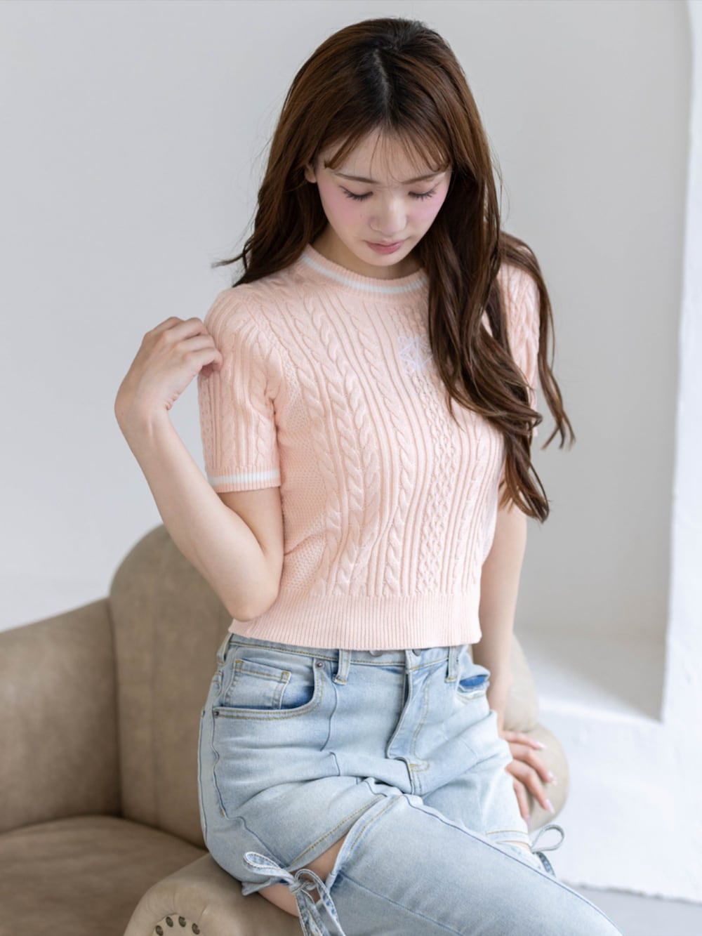 ホワイト系のパンプス、ブルー系のデニムパンツ、ピンク系のニット/セーターを着用したレディースの夏コーディネートの3枚目の写真