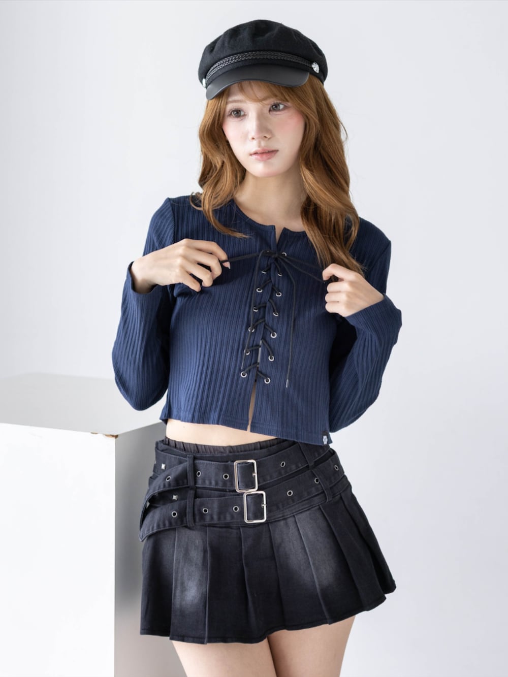 ブラック系のスカート、ブラック系のブーツ、ブルー系のTシャツ/カットソーを着用したレディースの秋コーディネートの8枚目の写真