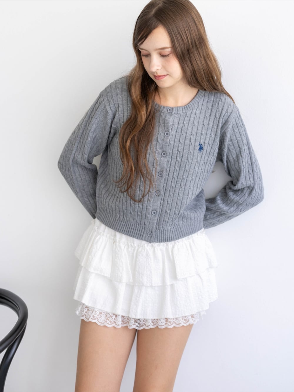 レッド系のパンプス、グレー系のカーディガン/ボレロ、ホワイト系のスカートを着用したレディースの秋コーディネートの10枚目の写真
