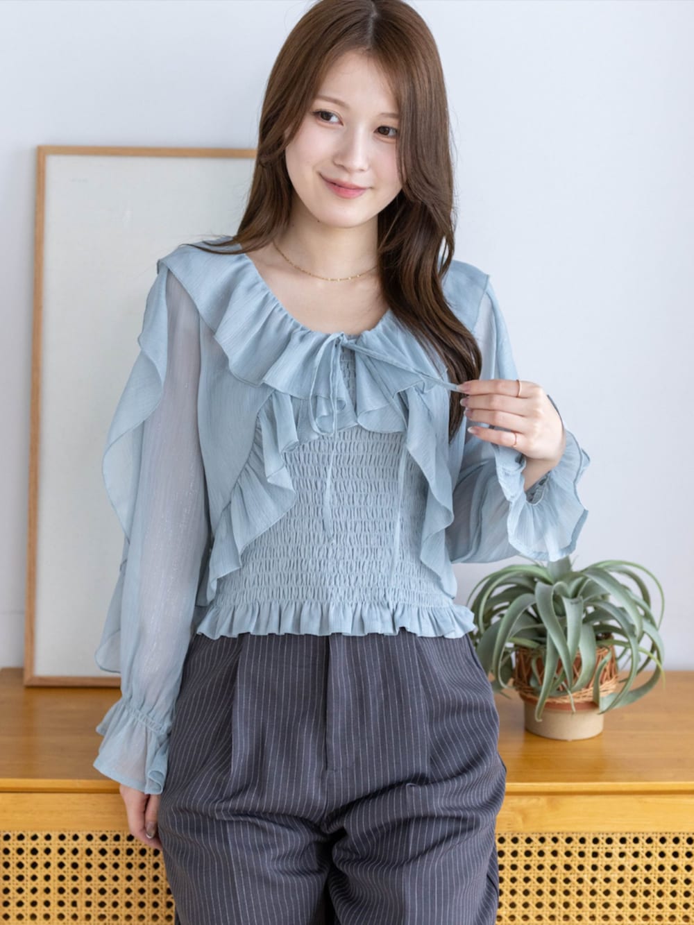 ブラック系のパンプス、グレー系のスラックス、グリーン系のシャツ/ブラウスを着用したレディースの夏コーディネートの3枚目の写真