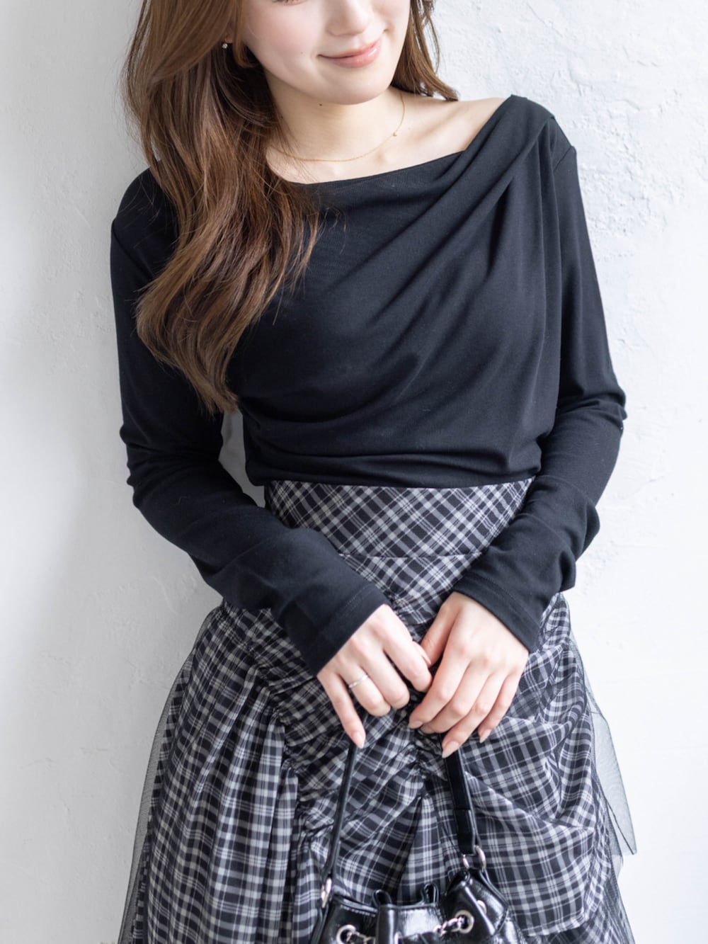 ブラック系のハンドバッグ、ブラック系のTシャツ/カットソー、ブラック系のスカートを着用したレディースの春コーディネートの6枚目の写真