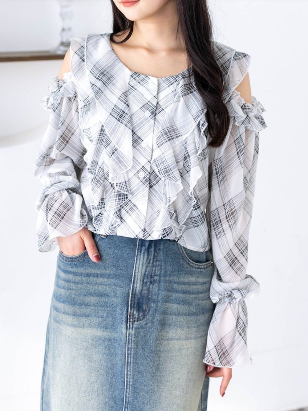 ブラック系のブーツ、ブルー系のスカート、ホワイト系のシャツ/ブラウスを着用したレディースの春コーディネートの2枚目の写真