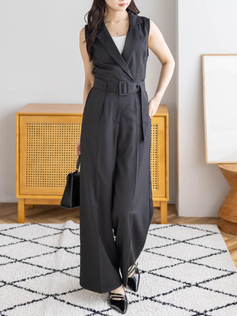 ブラック系のパンプス、ブラック系のハンドバッグ、ブラック系のつなぎ/オールインワンを着用したレディースの夏コーディネートの4枚目の写真