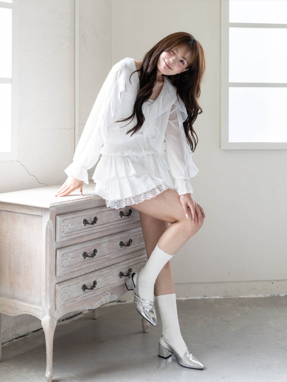 シルバー系のパンプス、ホワイト系のスカート、ホワイト系のシャツ/ブラウスを着用したレディースの春コーディネートの2枚目の写真