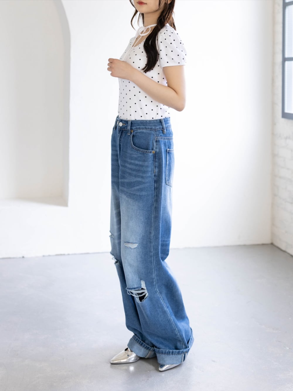 シルバー系のパンプス、ホワイト系のTシャツ/カットソー、ブルー系のデニムパンツを着用したレディースの夏コーディネートの2枚目の写真