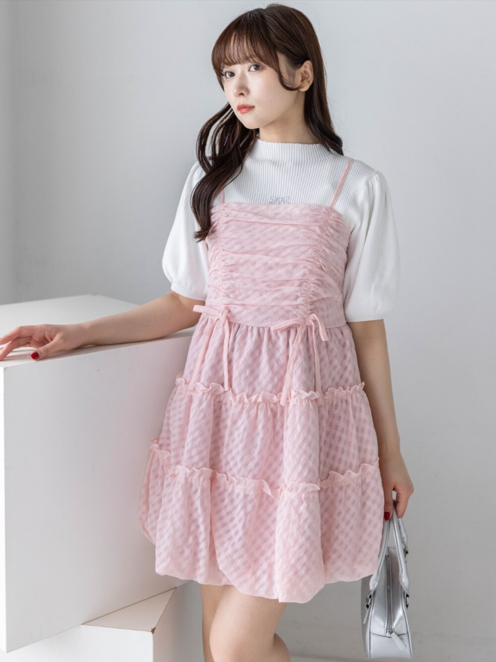 シルバー系のパンプス、ホワイト系のニット/セーター、ピンク系のワンピースを着用したレディースの春コーディネートの7枚目の写真