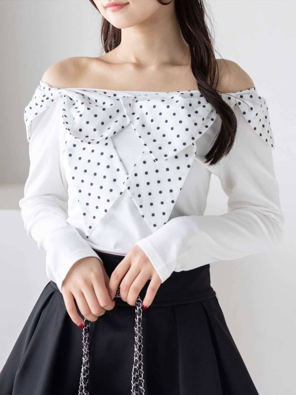 ブラック系のブーツ、ホワイト系のTシャツ/カットソー、ブラック系のスカートを着用したレディースの秋コーディネートの4枚目の写真