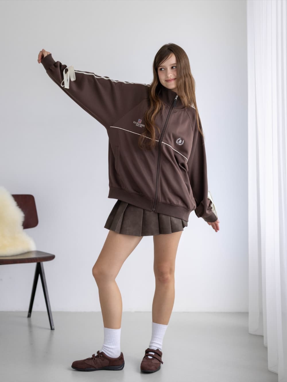 ブラウン系のスカート、ブラウン系のTシャツ/カットソー、ブラウン系のスニーカーを着用したレディースの秋コーディネートの3枚目の写真