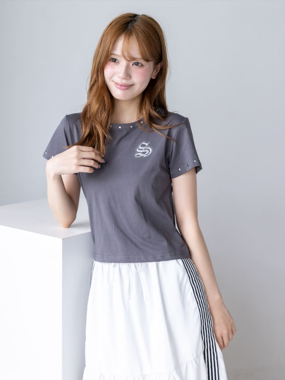 ブラック系のブーツ、ホワイト系のスカート、グレー系のTシャツ/カットソーを着用したレディースの夏コーディネートの6枚目の写真