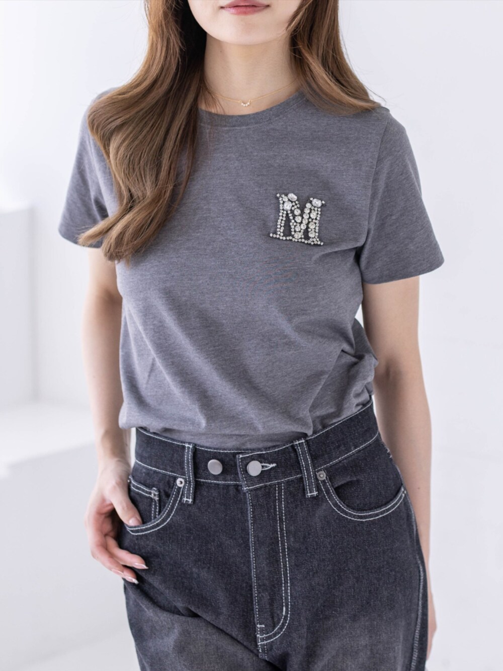 ブラック系のスニーカー、ブラック系のデニムパンツ、グレー系のTシャツ/カットソーを着用したレディースの春コーディネートの6枚目の写真