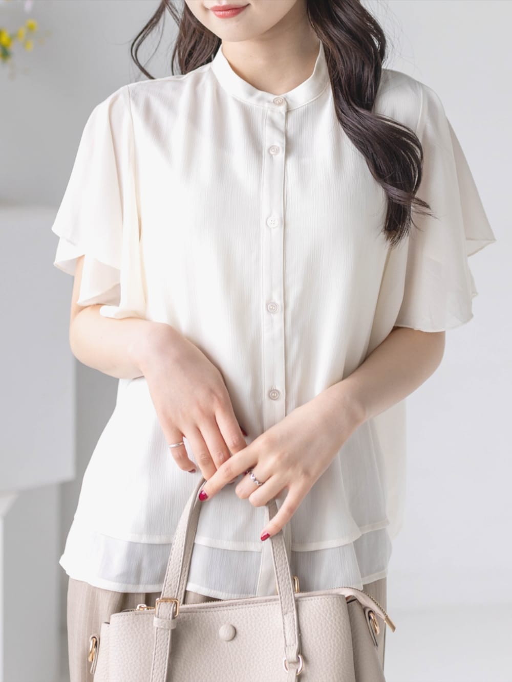 ベージュ系のスラックス、ホワイト系のパンプス、ホワイト系のシャツ/ブラウスを着用したレディースの夏コーディネートの8枚目の写真