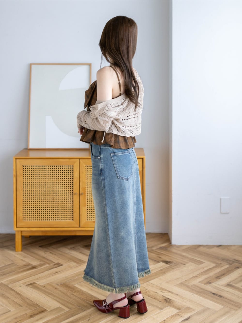 レッド系のパンプス、ブラウン系のニット/セーター、ブルー系のデニムスカートを着用したレディースの夏コーディネートの2枚目の写真