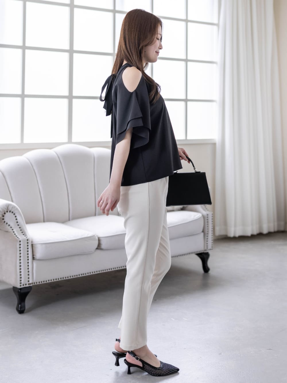 ホワイト系のその他パンツ、ブラック系のハンドバッグ、ブラック系のパンプスを着用したレディースの春コーディネートの3枚目の写真