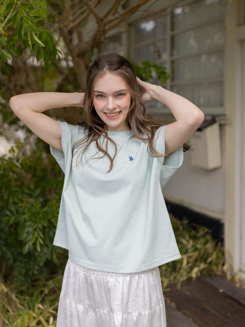 ホワイト系のスカート、グリーン系のTシャツ/カットソーを着用したレディースの夏コーディネートの6枚目の写真