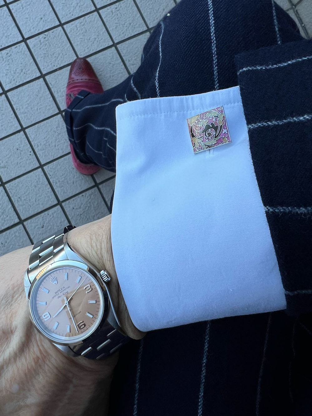 パープル系のビジネスシャツ、レッド系のネクタイ、レッド系のポケットチーフを着用したメンズの冬コーディネートの2枚目の写真