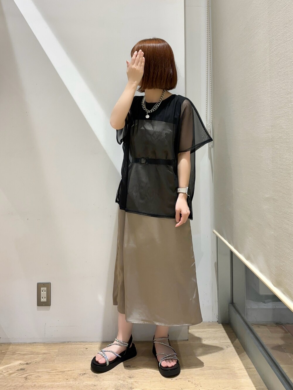 ブラック系のTシャツ/カットソー、ブラウン系のスカート、ブラック系のサンダルを着用したレディースの夏コーディネートの3枚目の写真