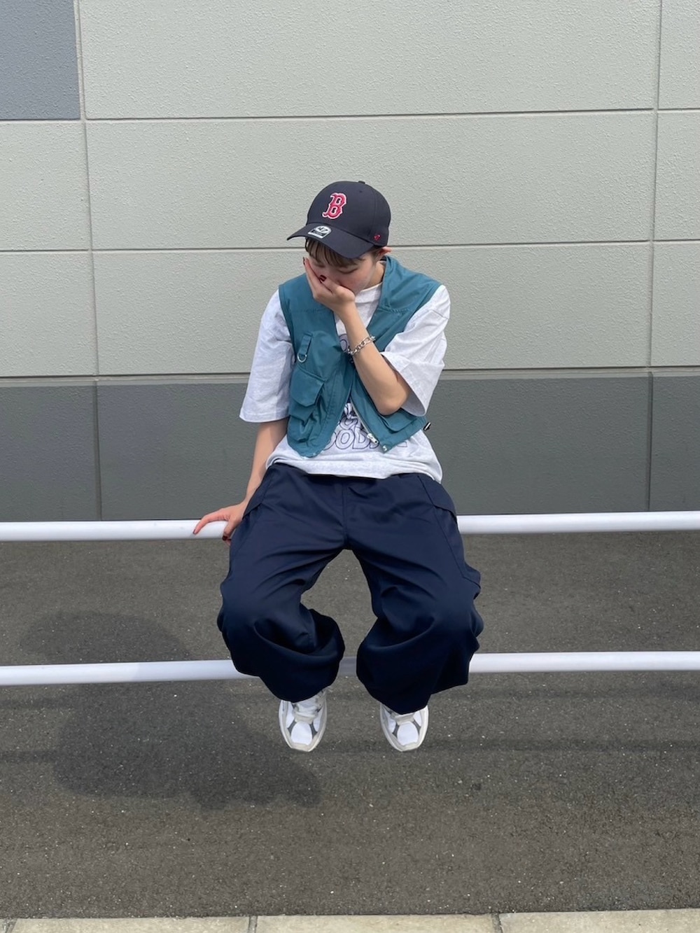 グレー系のTシャツ/カットソー、ブルー系のベスト、ブルー系のカーゴパンツを着用したレディースの夏コーディネートの3枚目の写真