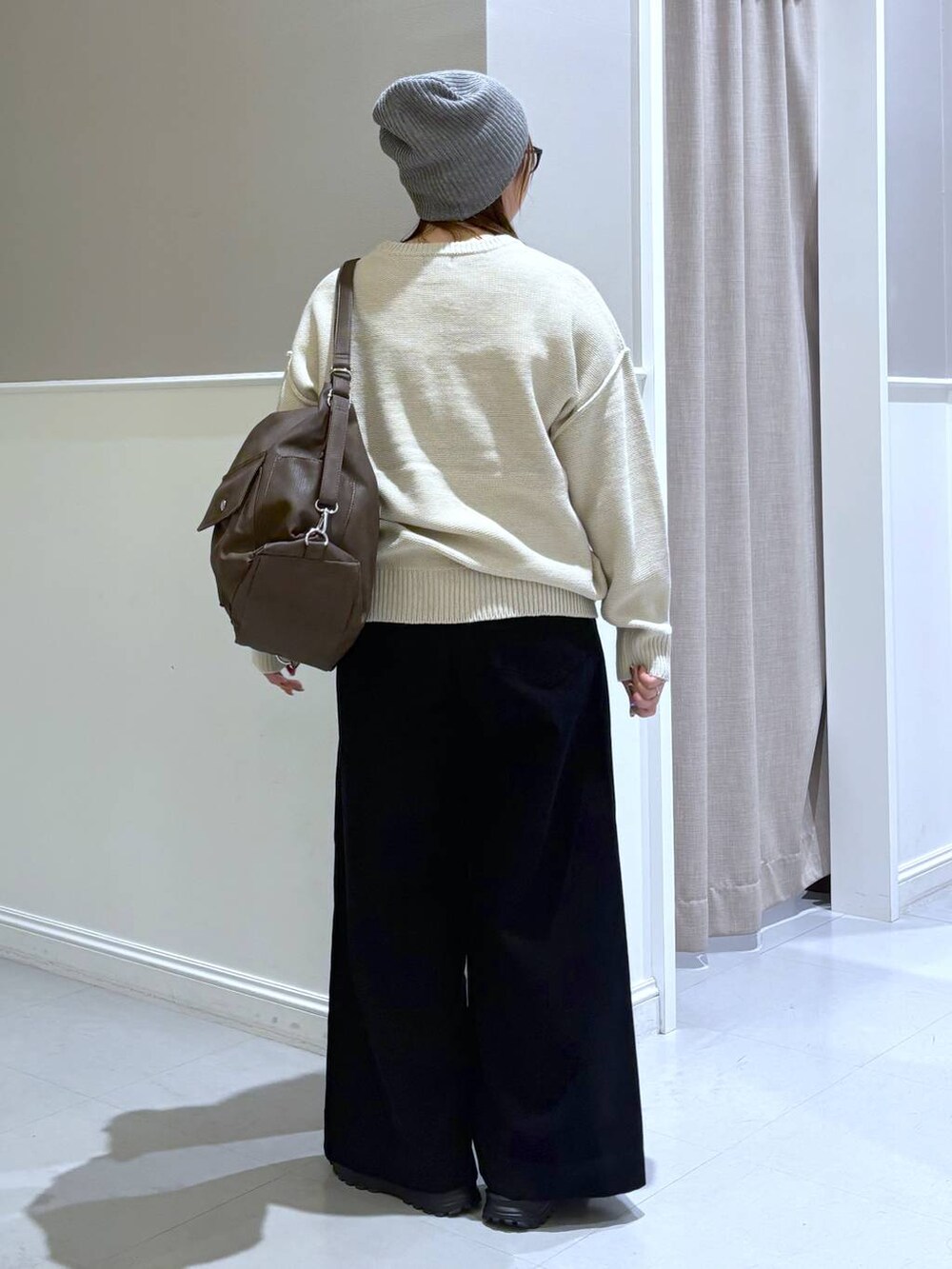 ブラック系のその他パンツ、ブラック系のその他シューズ、ブラウン系のショルダーバッグを着用したレディースの秋コーディネートの4枚目の写真