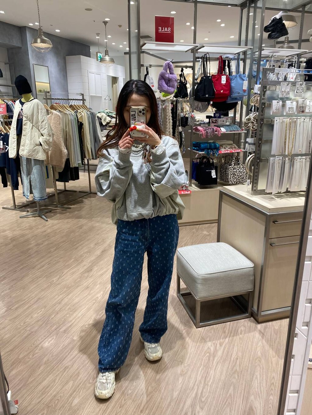 ブルー系のデニムパンツ、ホワイト系のTシャツ/カットソー、グレー系のスウェットを着用したレディースの冬コーディネートの3枚目の写真