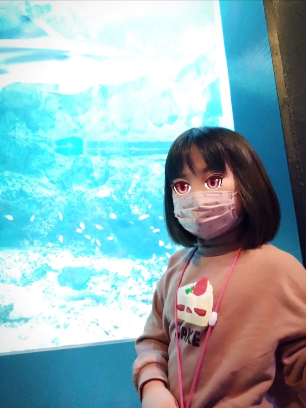 ブラウン系のダウンジャケット/コート、レッド系のスウェット、ブルー系のデニムパンツを着用したレディースの冬コーディネートの2枚目の写真