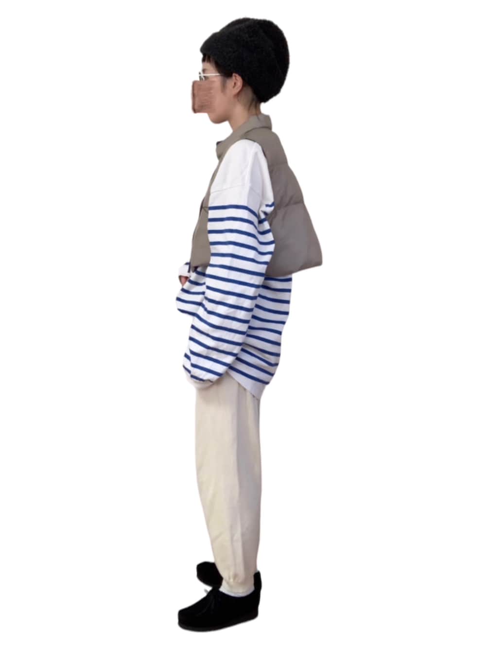 ブラック系のパンツ、ベージュ系のベスト、ブルー系のTシャツ/カットソーを着用したレディースの秋コーディネートの2枚目の写真