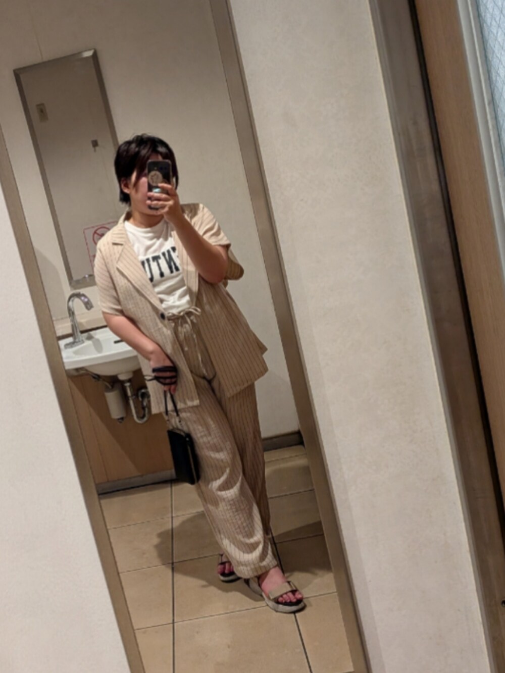 ベージュ系のサンダル、ホワイト系のTシャツ/カットソー、ベージュ系のその他を着用したレディースの春コーディネートの2枚目の写真