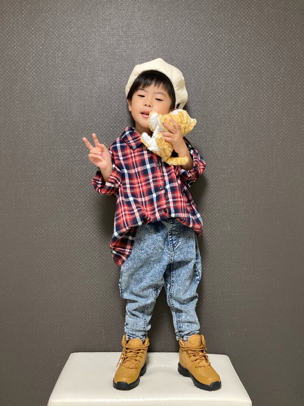 レッド系のシャツ/ブラウス、ブラウン系のブーツ、その他のハンチング/ベレー帽を着用したキッズの秋コーディネートの4枚目の写真