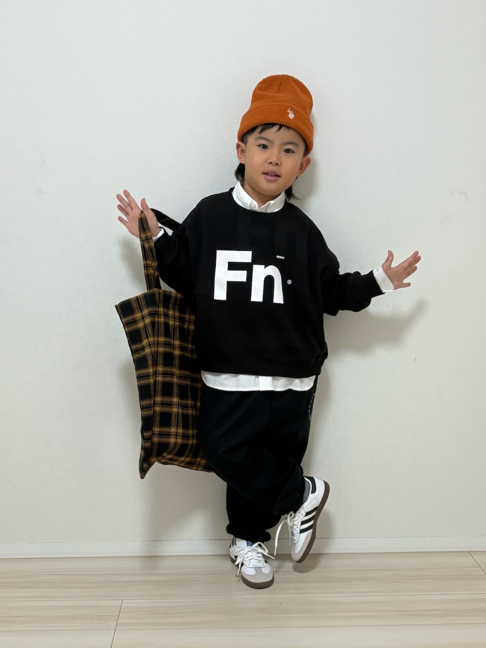 ブラック系のスウェット、ブラック系のスウェットパンツ、ホワイト系のスニーカーを着用したキッズの冬コーディネートの3枚目の写真