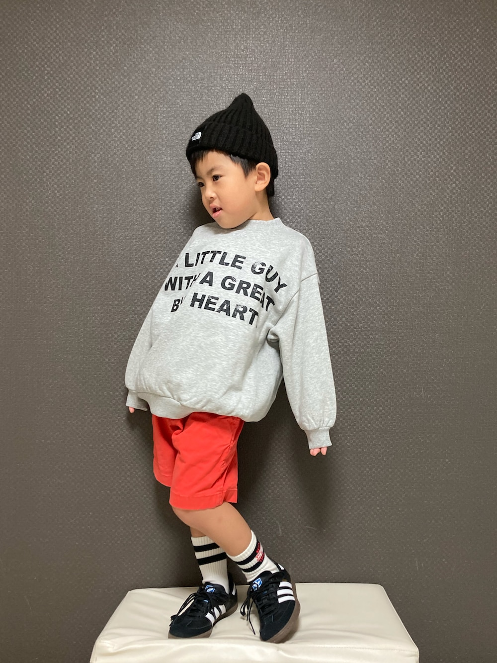 グレー系のスウェット、レッド系のその他パンツ、ブラック系のスニーカーを着用したキッズの秋コーディネートの2枚目の写真