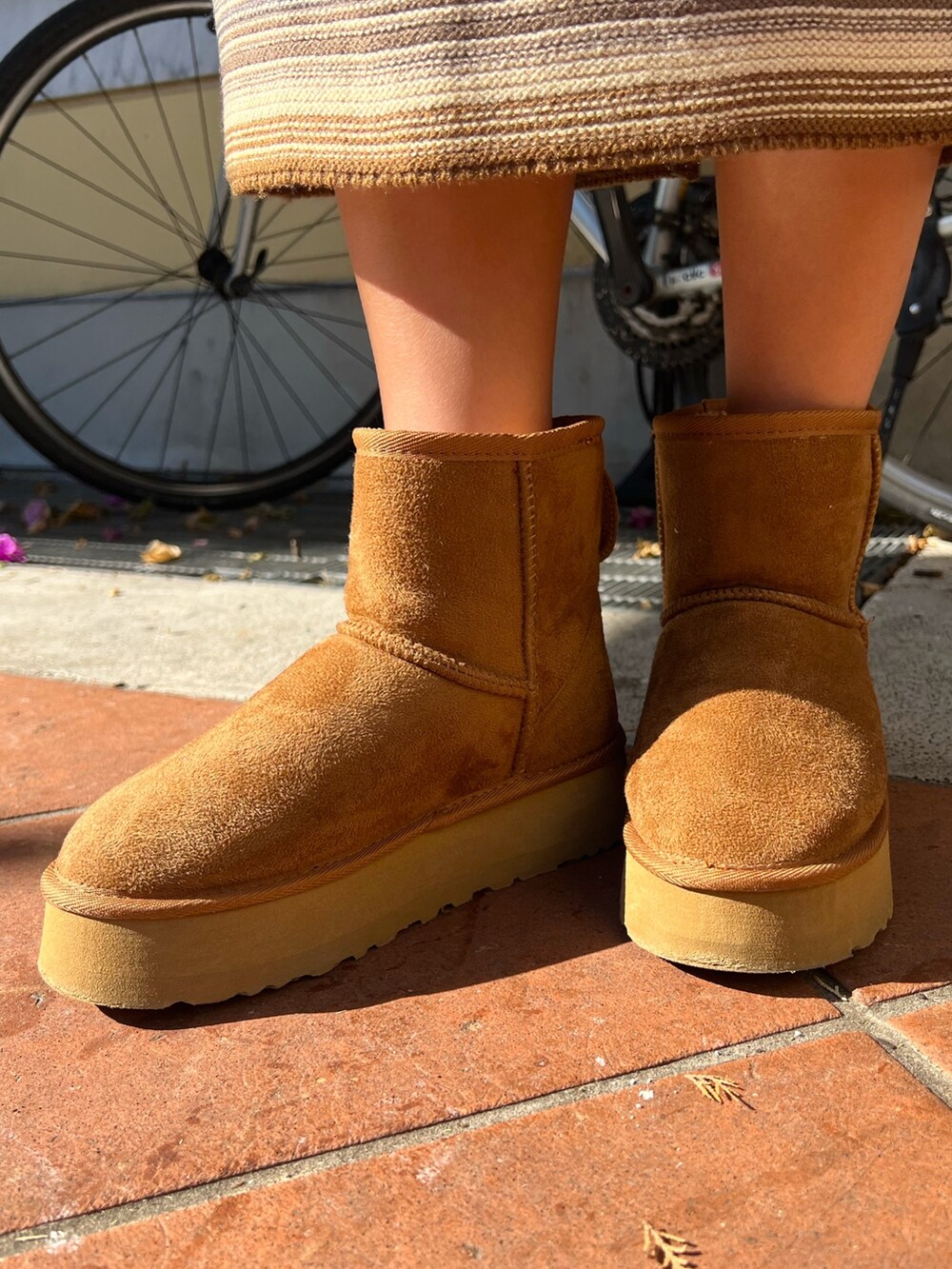 イエロー系のブーツ、ブラウン系のスカート、ベージュ系のスウェットを着用したレディースの冬コーディネートの8枚目の写真