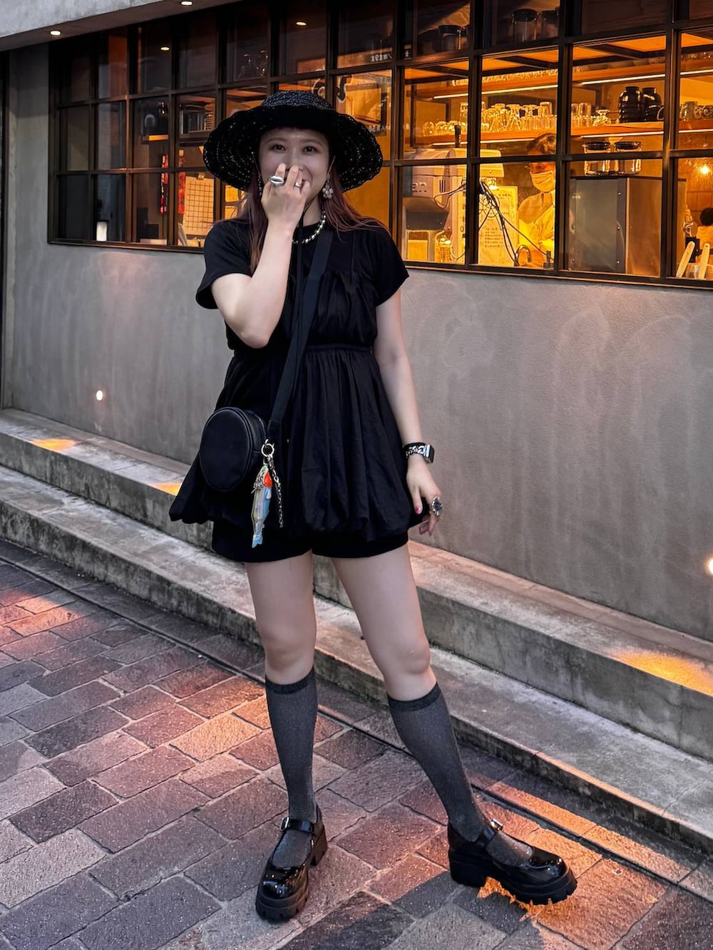 ブラック系のシャツ/ブラウス、ブラック系のTシャツ/カットソー、ブラック系のハットを着用したレディースの夏コーディネートの2枚目の写真